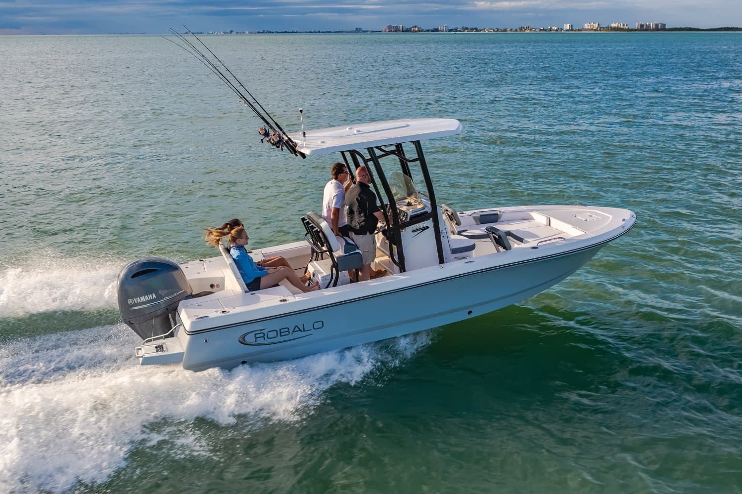 Robalo 226 Cayman bay boat running across open bay water with four people aboard