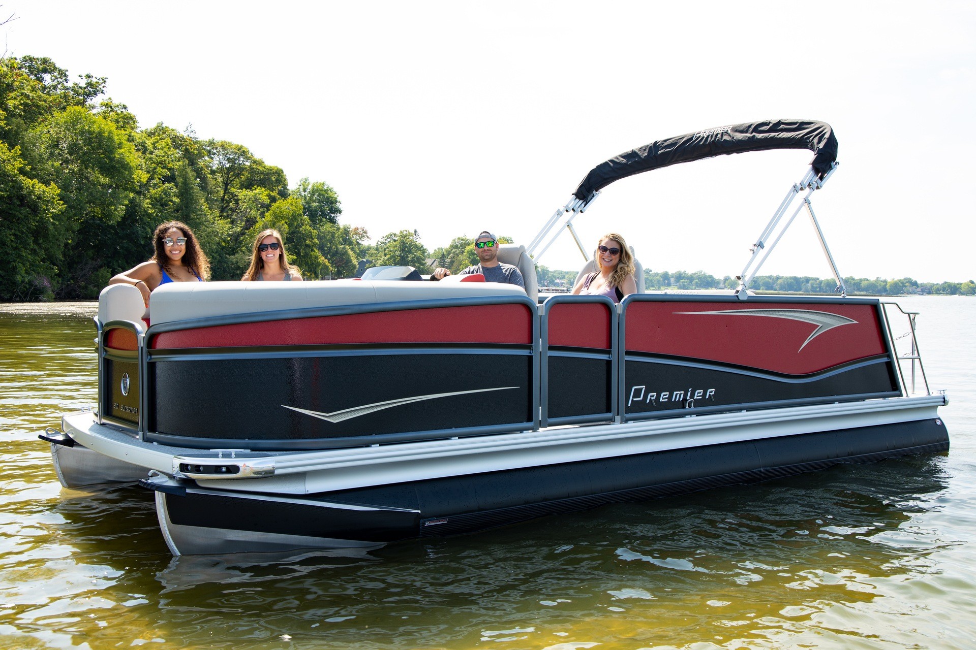 four people on a premier pontoon on the water