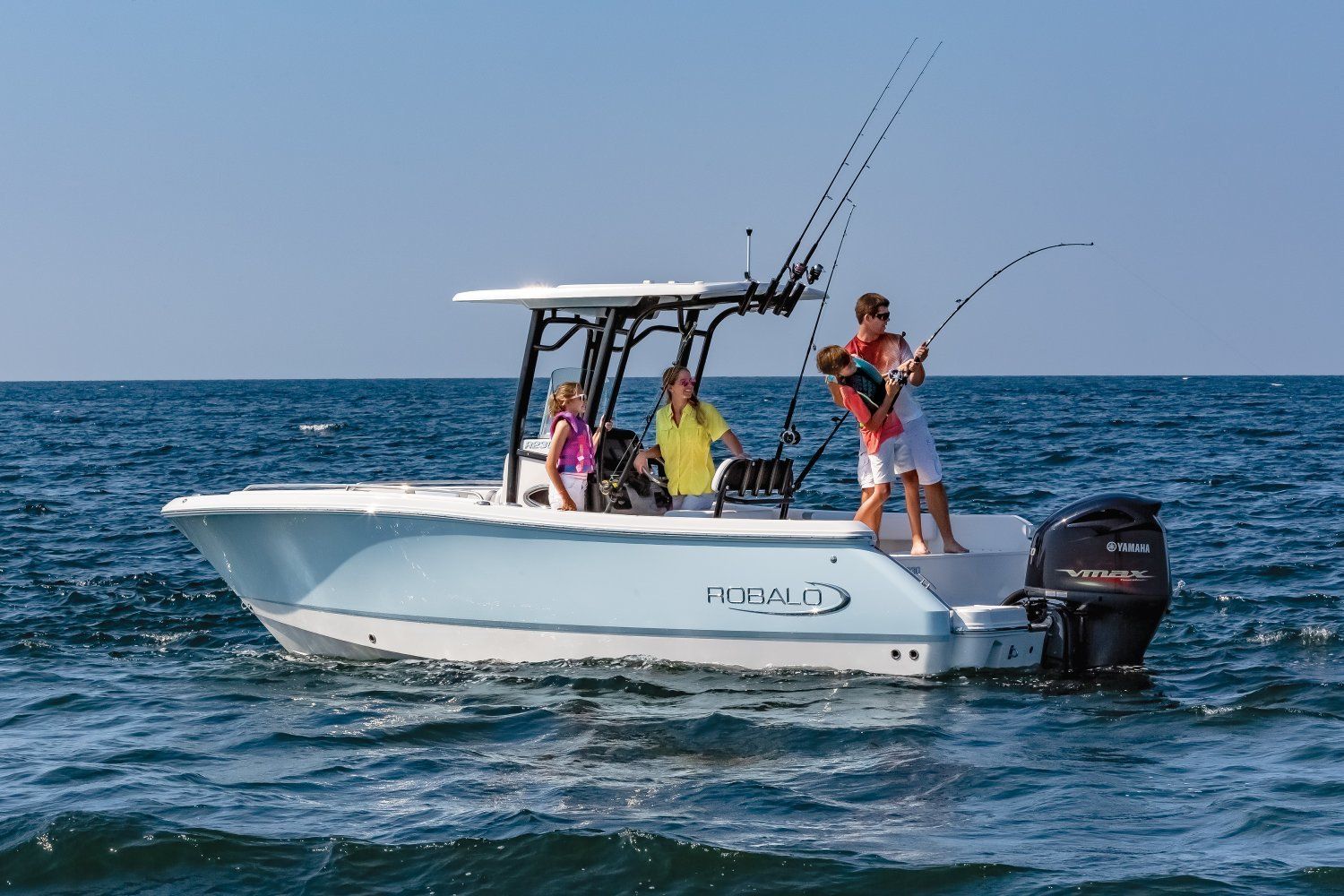 Image Robalo Center Console Boats: The R230 A family of four, with the dad and the son fishing, all on a Robalo R230