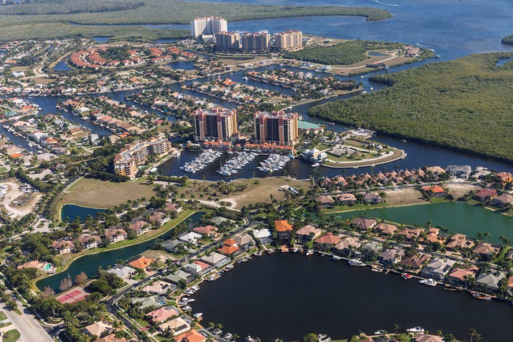 Image Dock & Dine: 2022 Guide to Boating-Friendly Dining in Fort Myers & Naples Aerial view of city and gulf Cape Coral, Florida. The Westin Cape Coral Resort at Marina Village